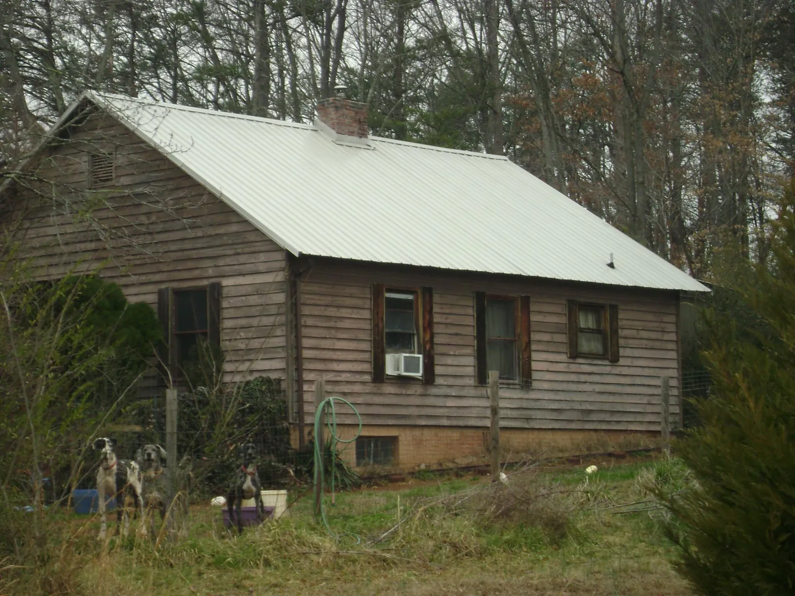 White metal roof on an old wood sided farmhouse, from a Metal Roof Installation job in Goodlettsville
